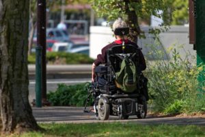 man outside cruising in lightweight electric wheelchair